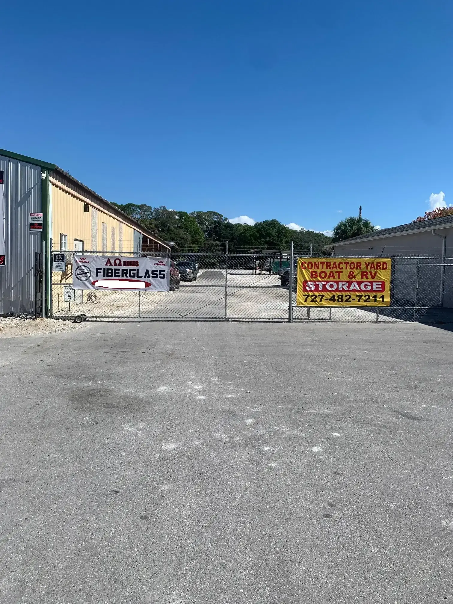 Secure gated entrance at the Leo Kidd storage facility in Port Richey, FL